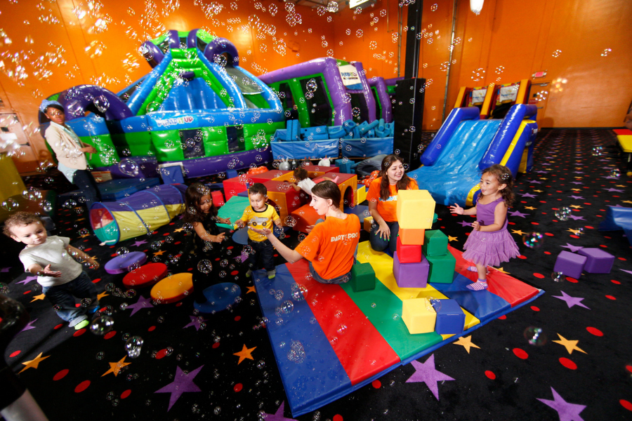 Pump It Up 100% private playdate with kids and parents playing in arena